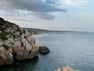 Un Paysage Cotier Serein Avec Un Premier Plan Rocheux Une Eau Calme Et Un Ciel